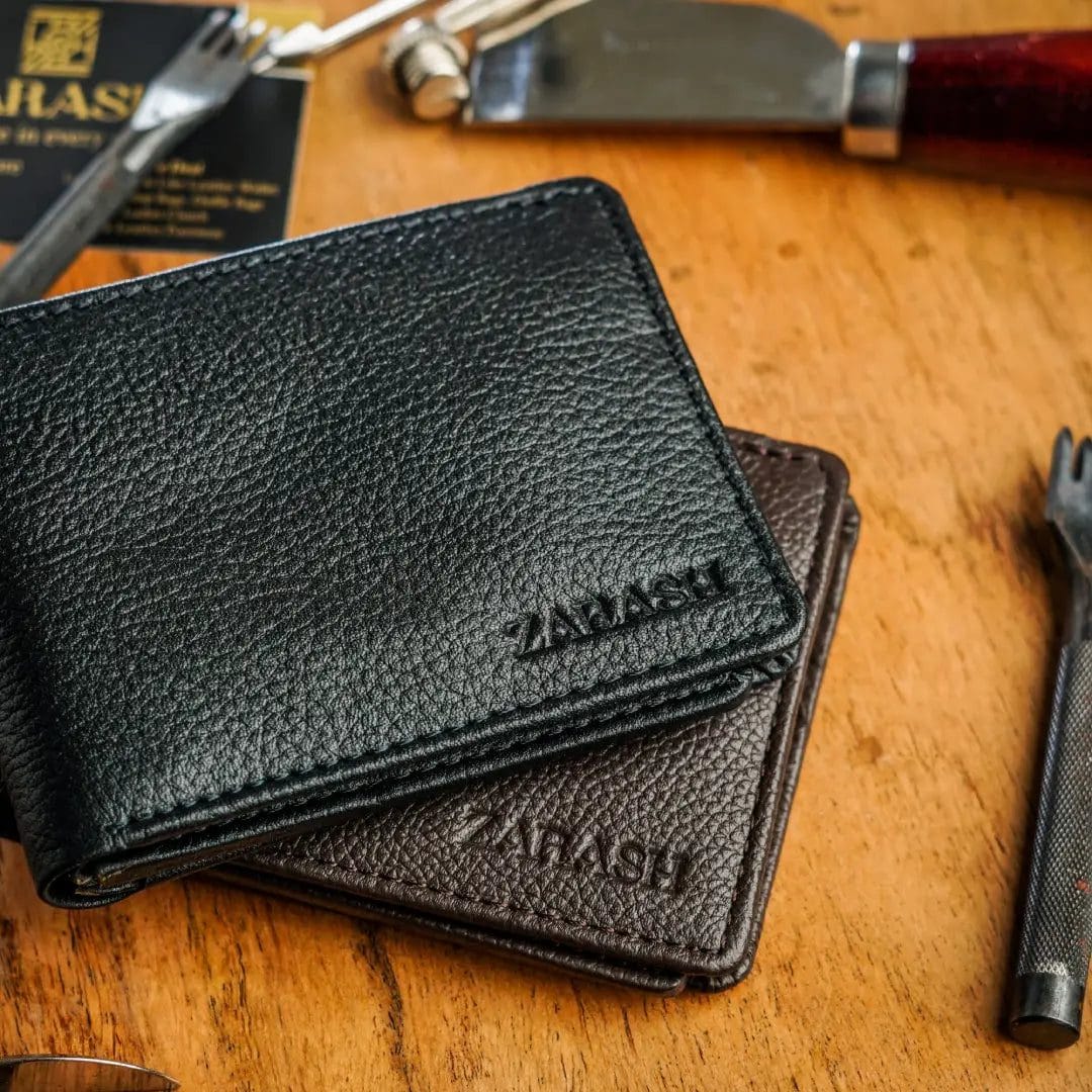 Two black leather wallets with 'ZAMASH' branding on a wooden surface.